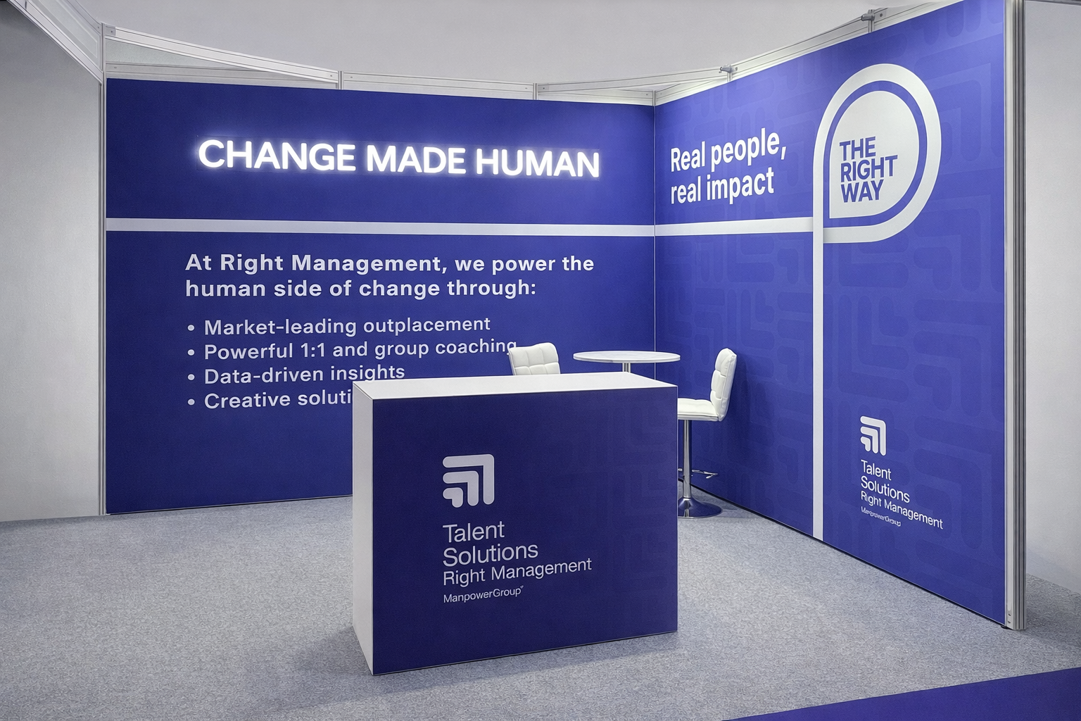 Exhibition booth with blue walls displaying the text 'CHANGE MADE HUMAN' and information about talent solutions and smart management. There is a white table with two white chairs and a counter with the logo 'Talent Solutions Right Management'.