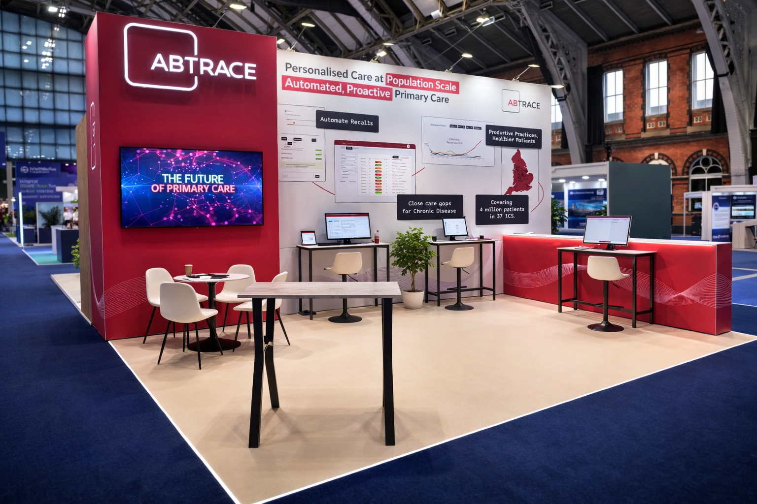Trade show booth for ABTRACE, showcasing healthcare technology with laptops, informational posters, a large screen, and a seating area.