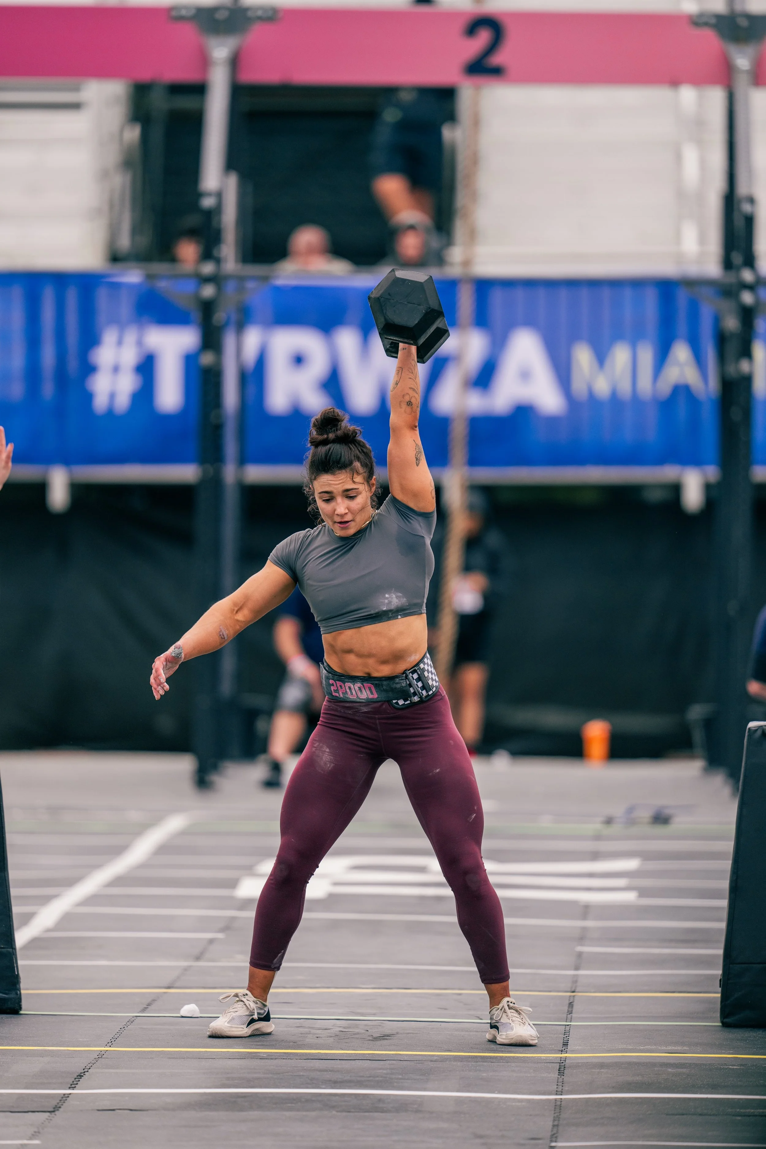 Woman lifting a dumbbell during a fitness competition at the CrossFit Games in Miami