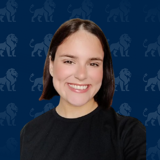 A young woman with shoulder-length brown hair smiling at the camera against a blue background with a lion logo pattern.