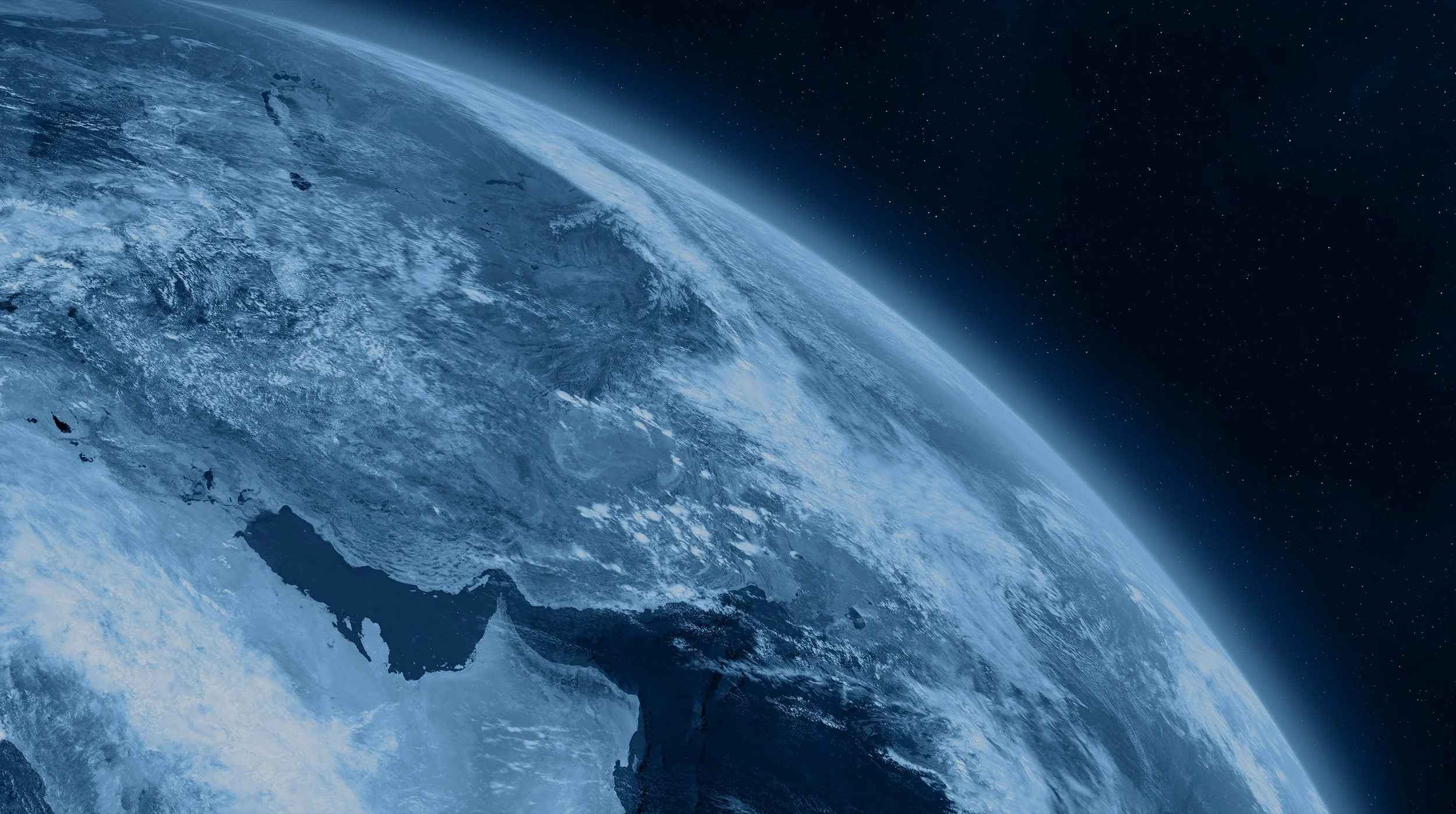 A view of Earth from space showing land, water, and cloud formations with stars in the background.