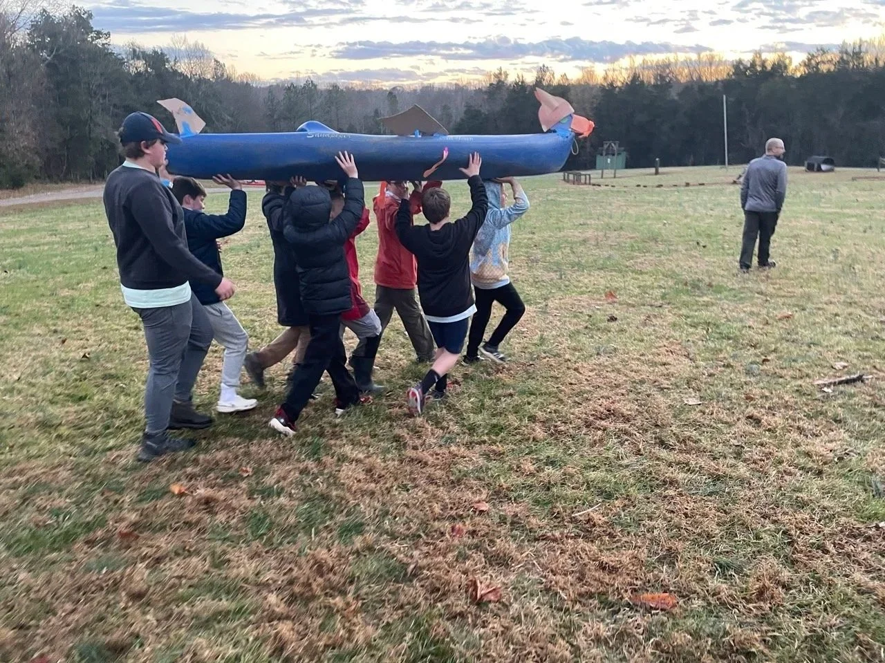 Boy Scouts carrying a canoe