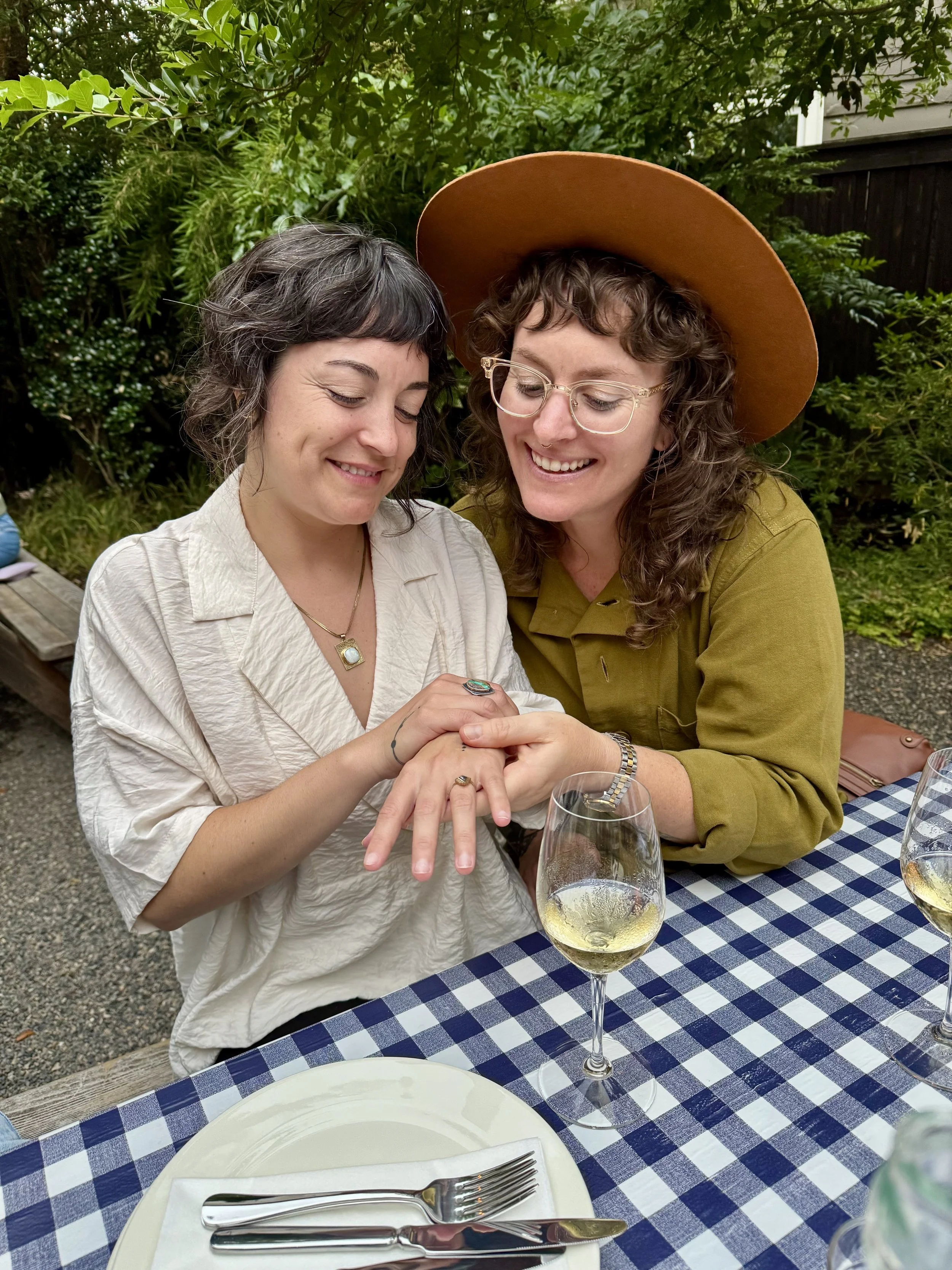 Admiring our engagement rings with friends at dinner