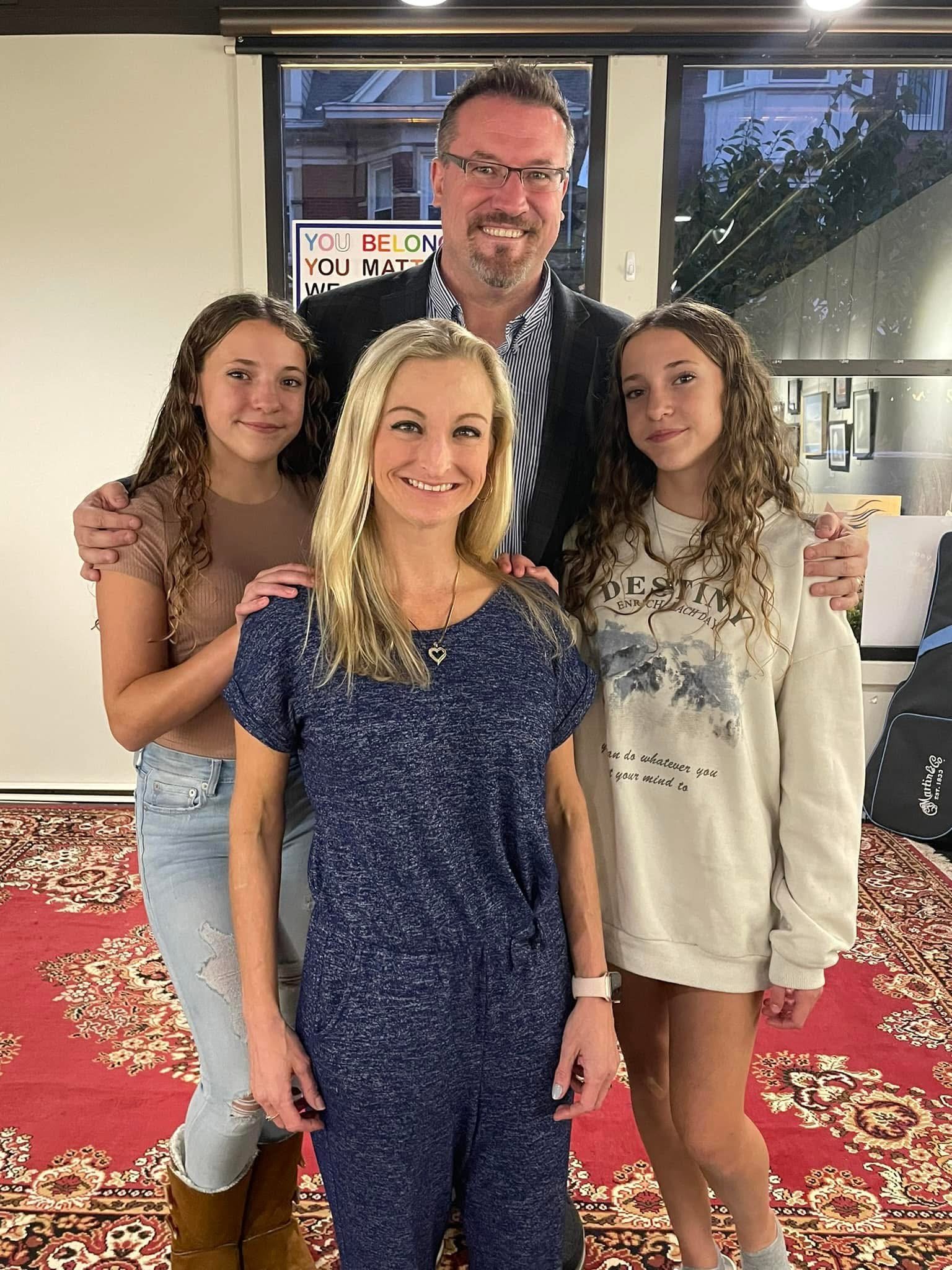 Jeff standing with his family.