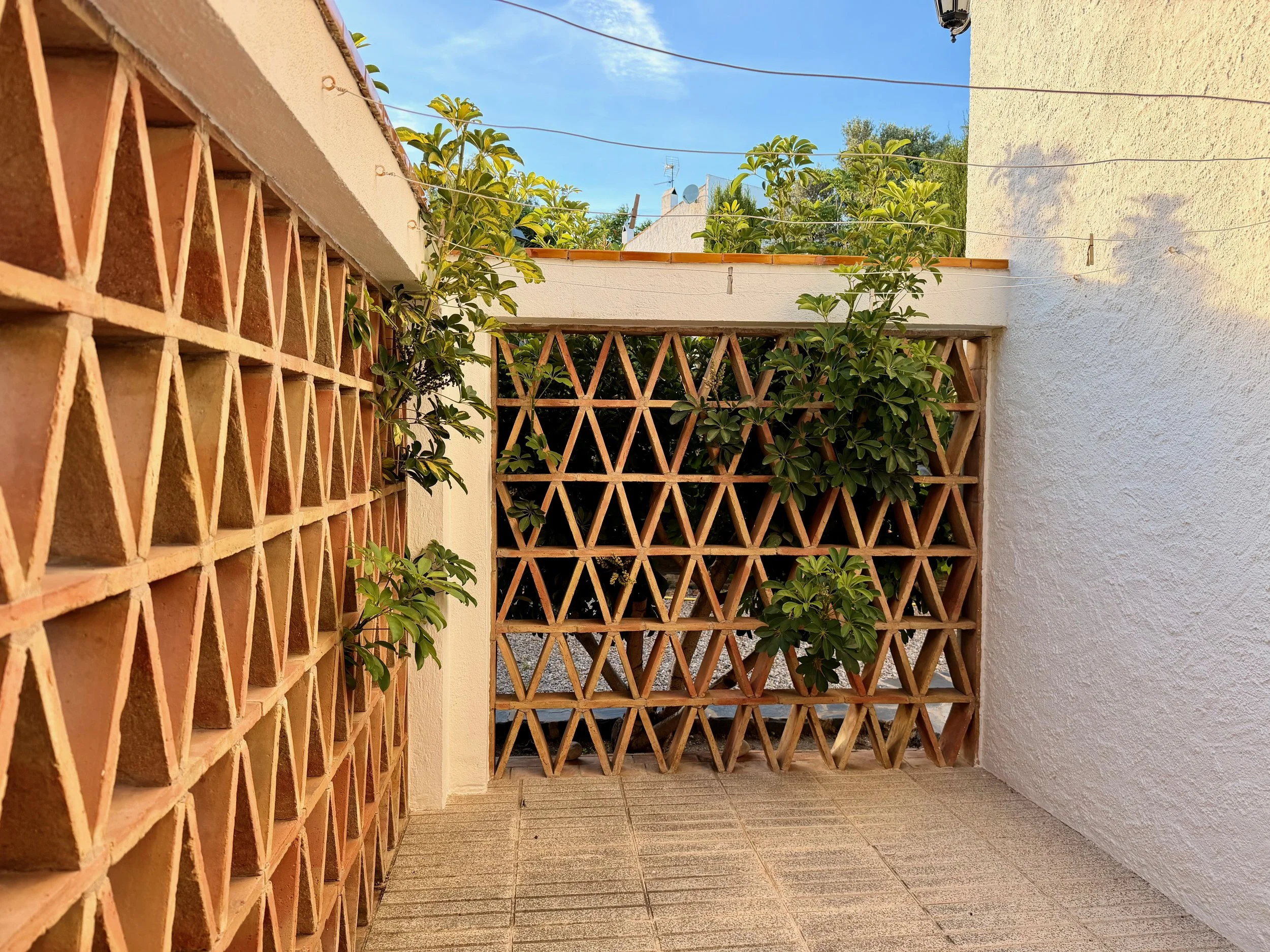 Lavadero equipado en Ca la Nuri - Cadaqués. Lavadora, secadora, fregadero para la ropa y tendedero amplio en el jardín interior.