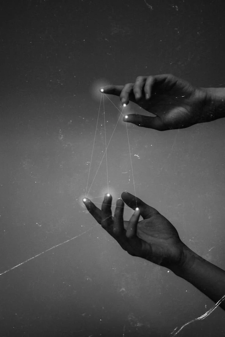 Two hands reaching towards a starry night sky, connecting with laser lines, creating a geometric pattern.