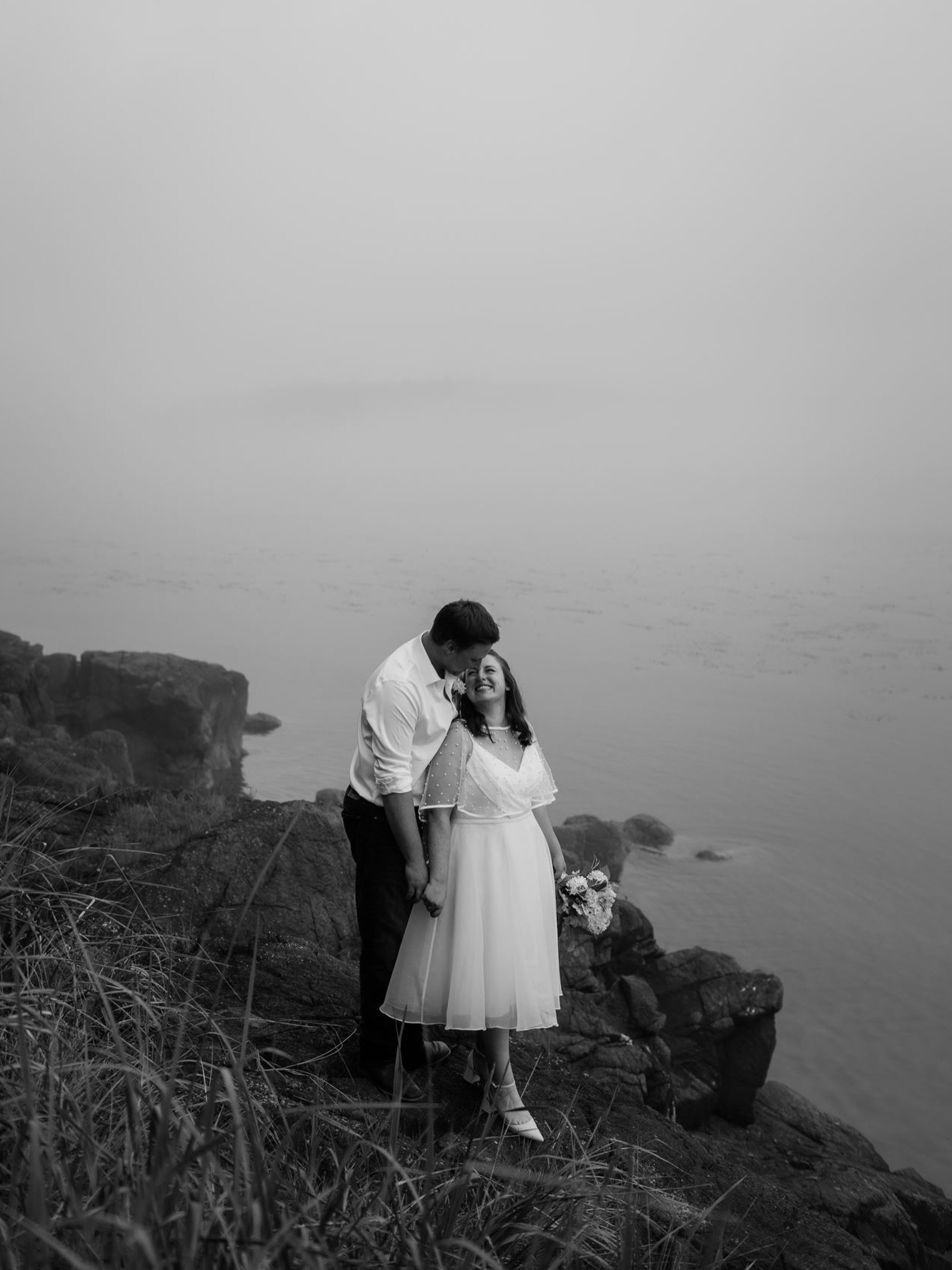 They exchanged their vows in the morning fog, accompanied by the breath of a passing humpback echoing across the water.