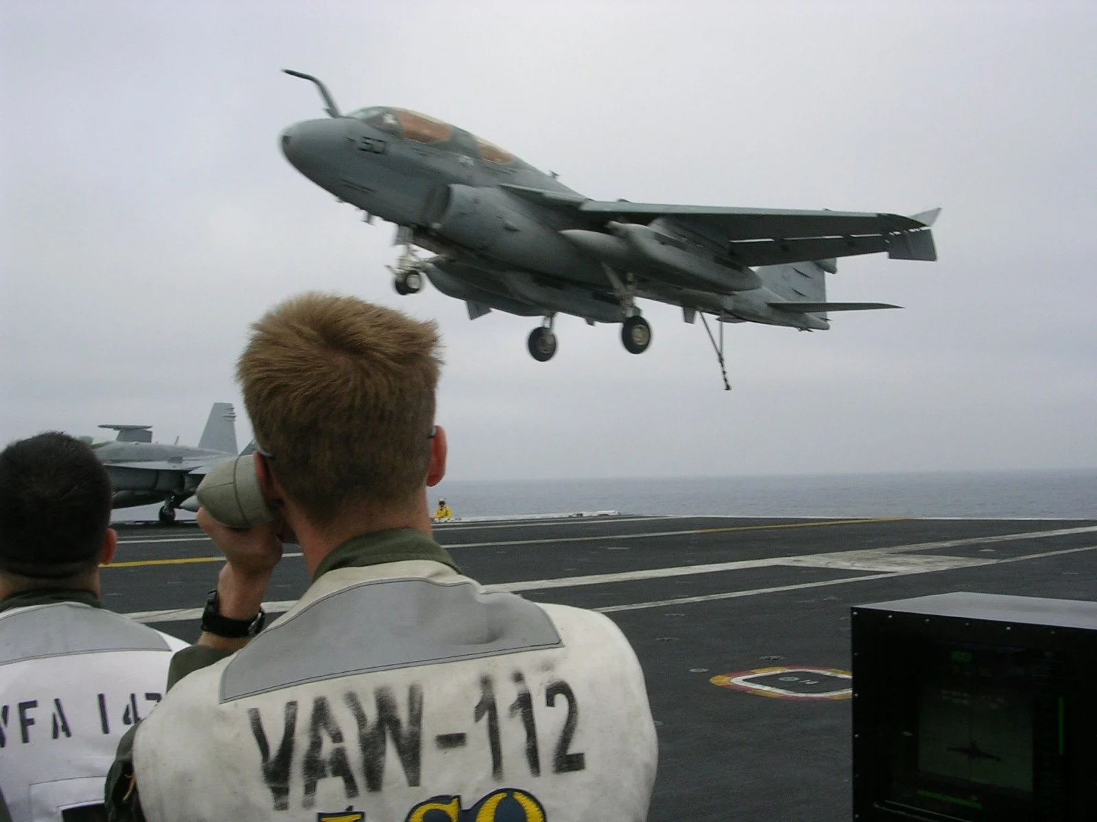 LSO watching an EA-6B land on an aircraft carrier