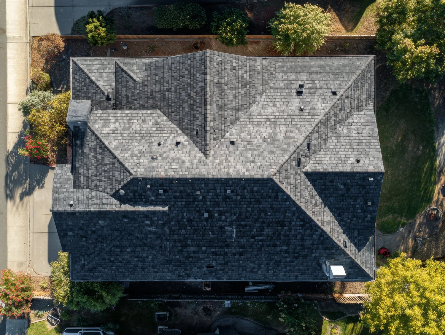Aerial drone view of a house with a gray shingle roof