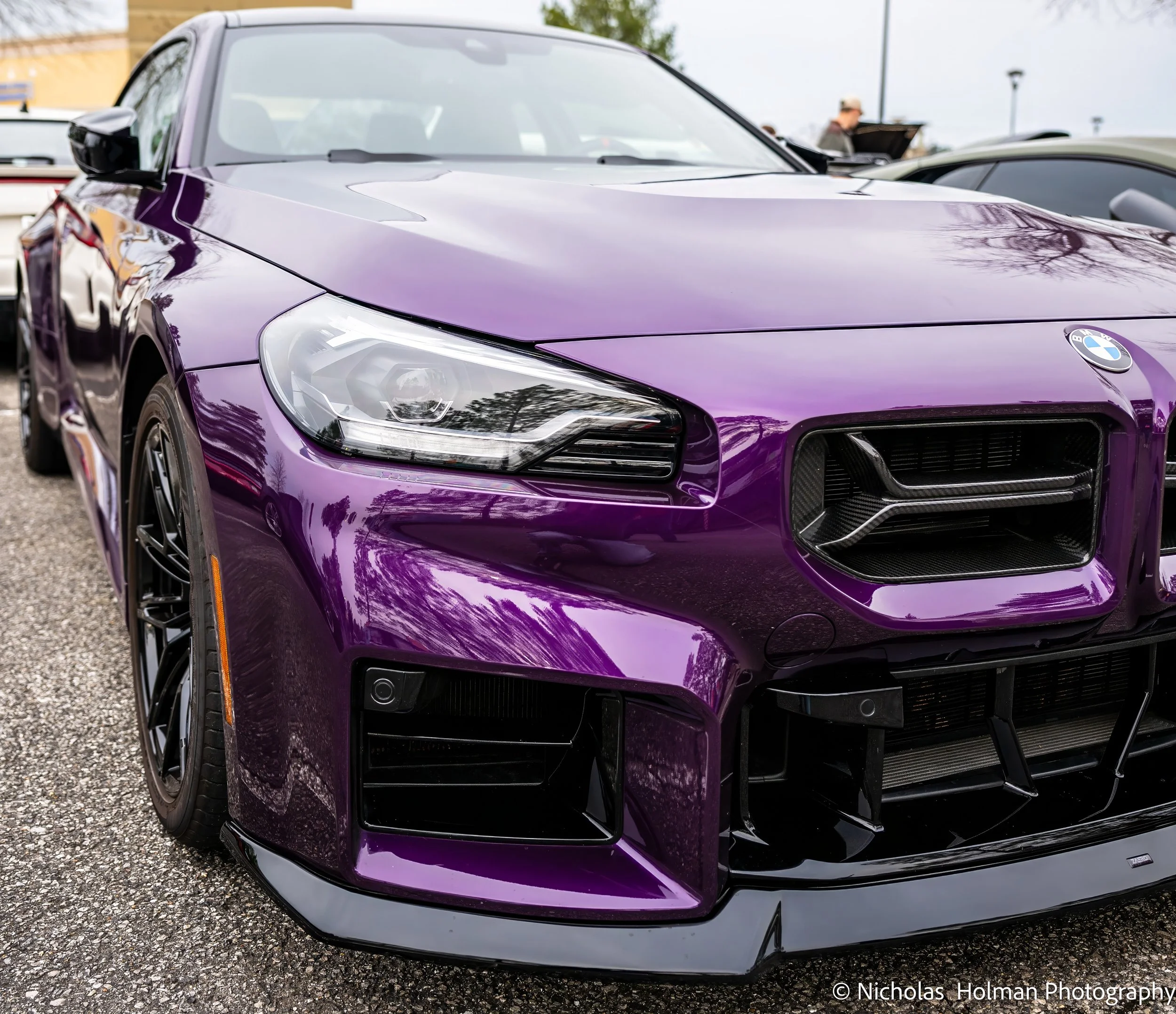A purple BMW sports car parked outdoors.