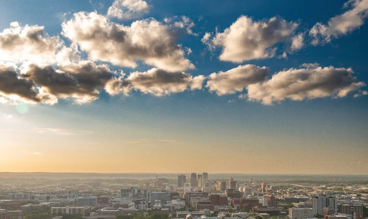 Vulcan statue and the Birmingham, Alabama skyline at sunset