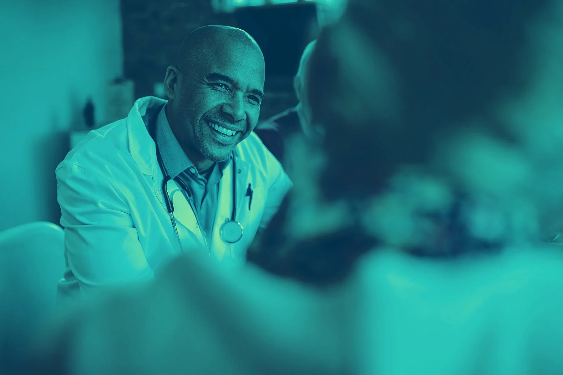 Smiling physician consulting with patient — join the Cagent Vascular team