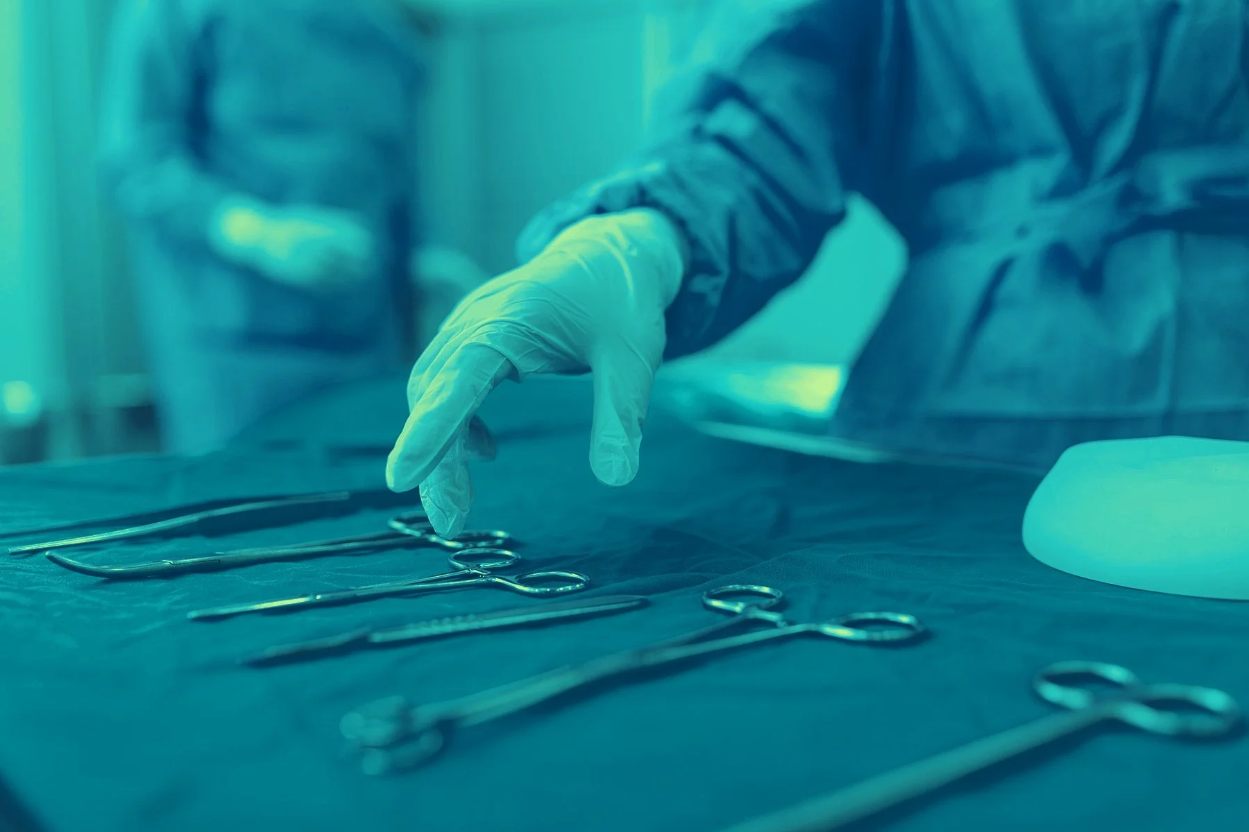 Physician preparing tools for peripheral vascular procedure