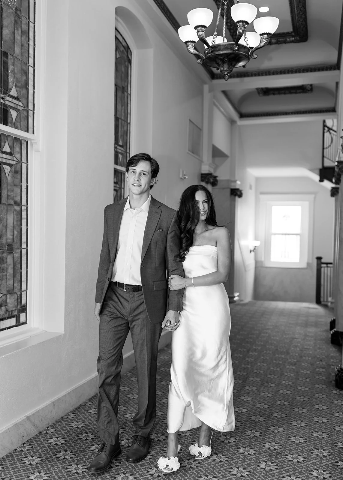 Couple walking together during indoor portraits.