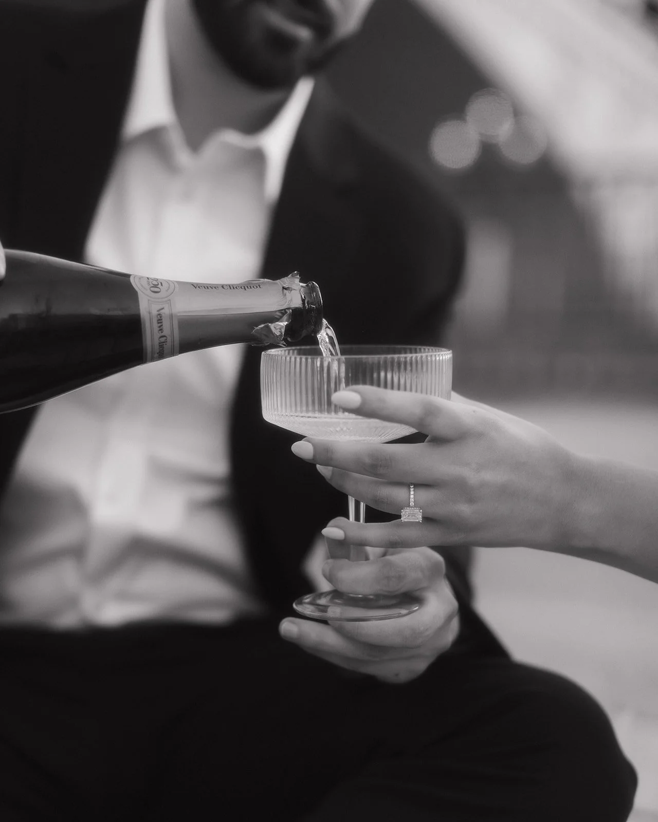 Champagne toast captured during modern engagement session.