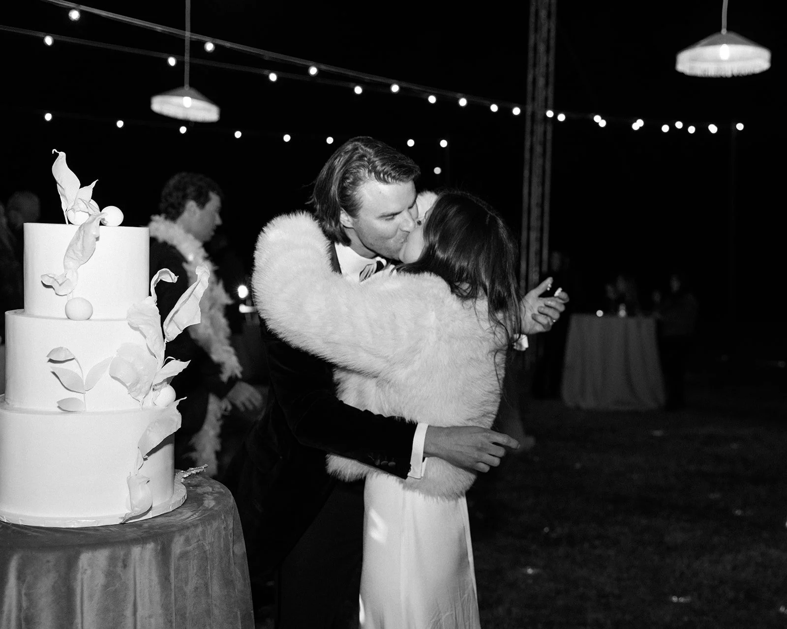 Cake cutting followed by a kiss.