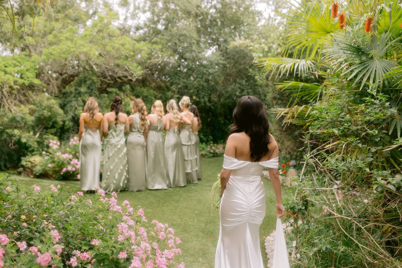 Bride getting ready to reveal her dress during a first look with the bridesmaids.