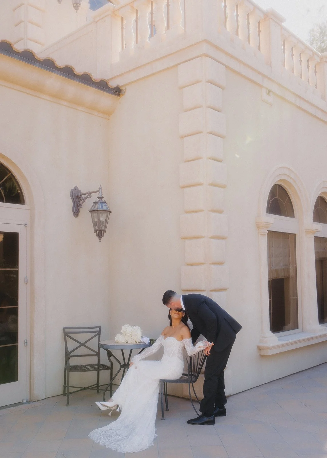 Editorial wedding portrait of bride and groom at chateau venue.