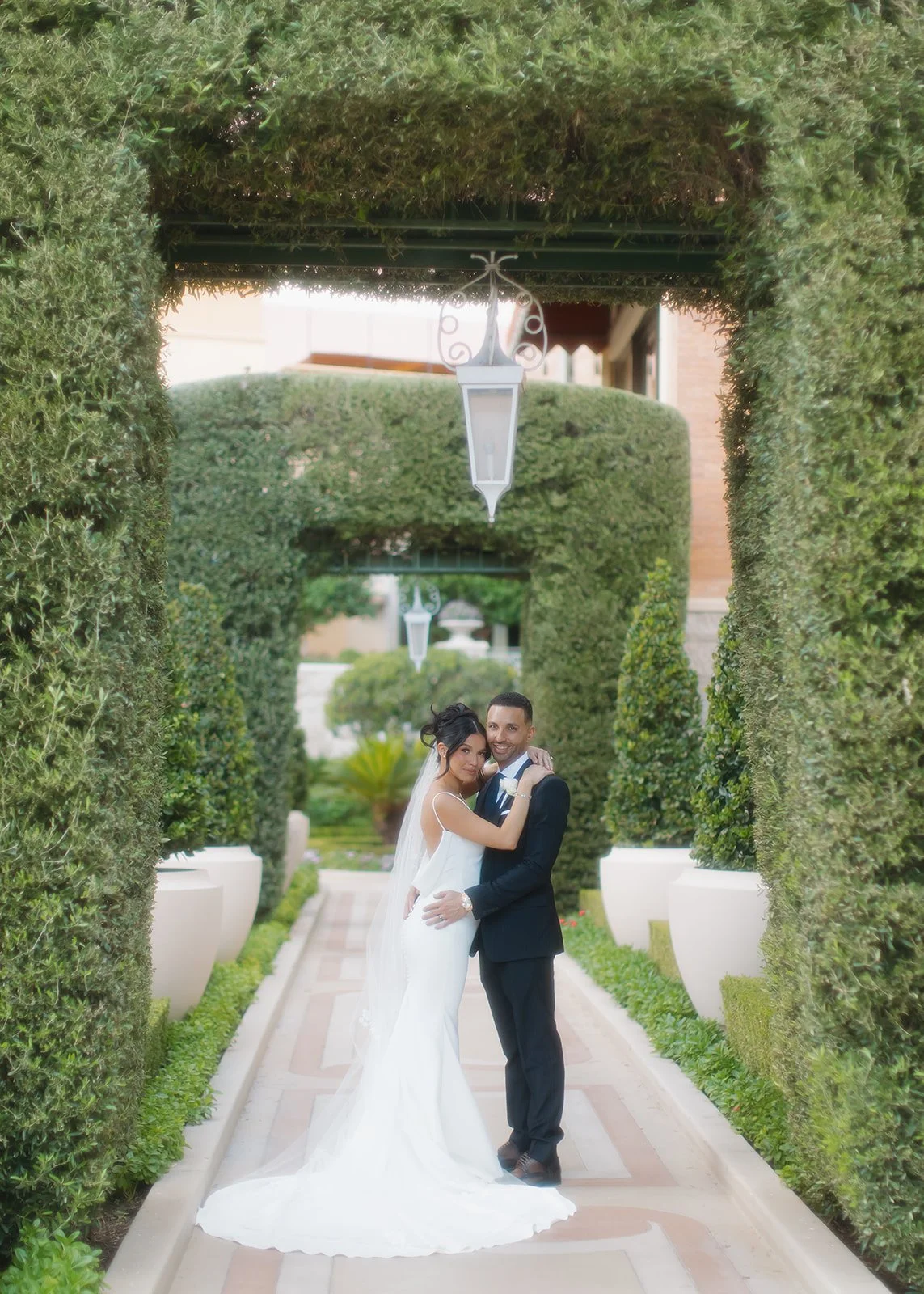 Soft, fashion-inspired couple portrait with garden background.