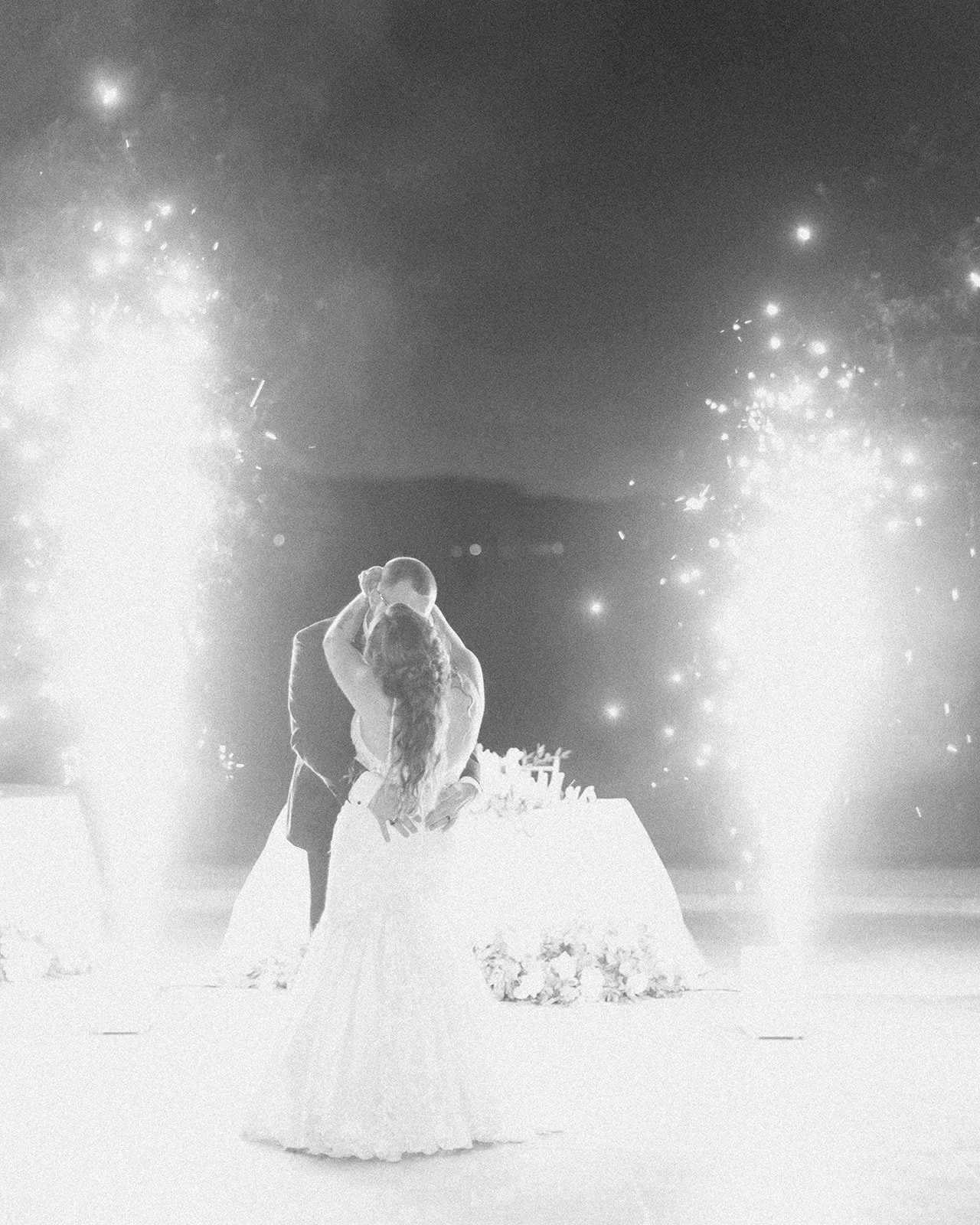 Romantic first dance moment surrounded by sparklers.