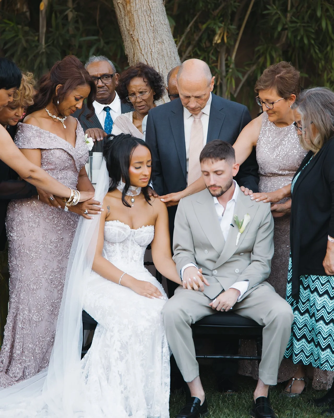 Emotional family prayer moment captured in a soft, documentary style.