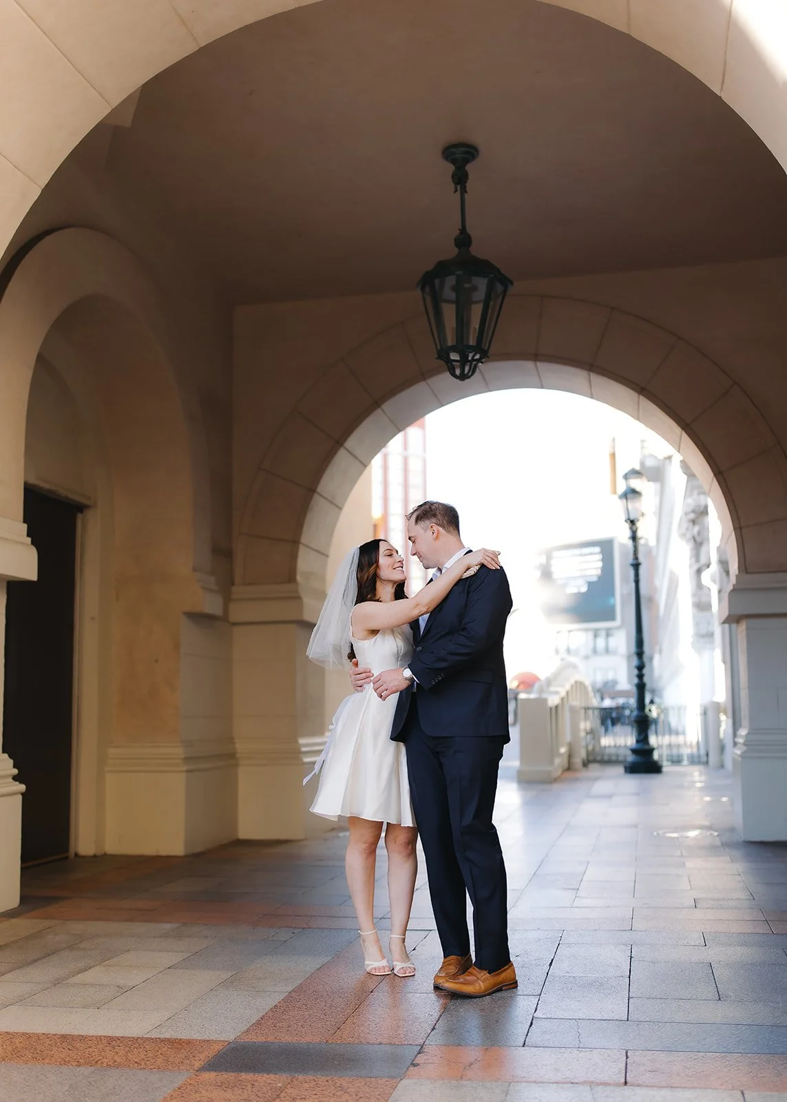 Composed engagement portrait highlighting architectural symmetry.