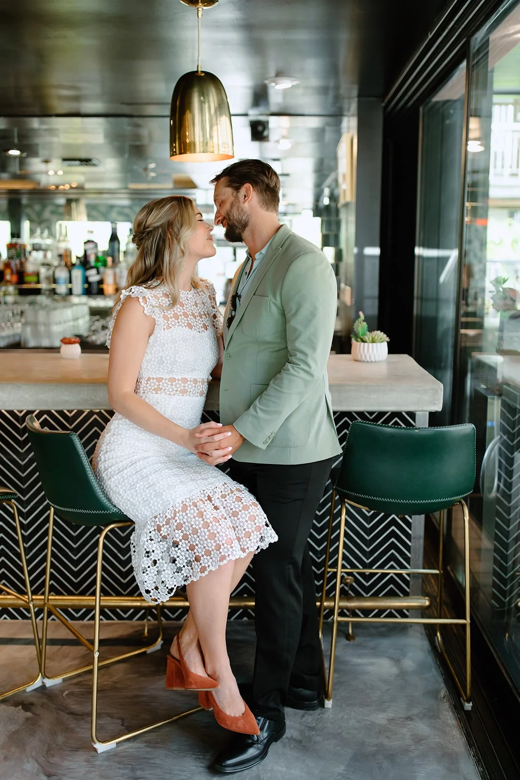 Couple holding hands during outdoor engagement session.