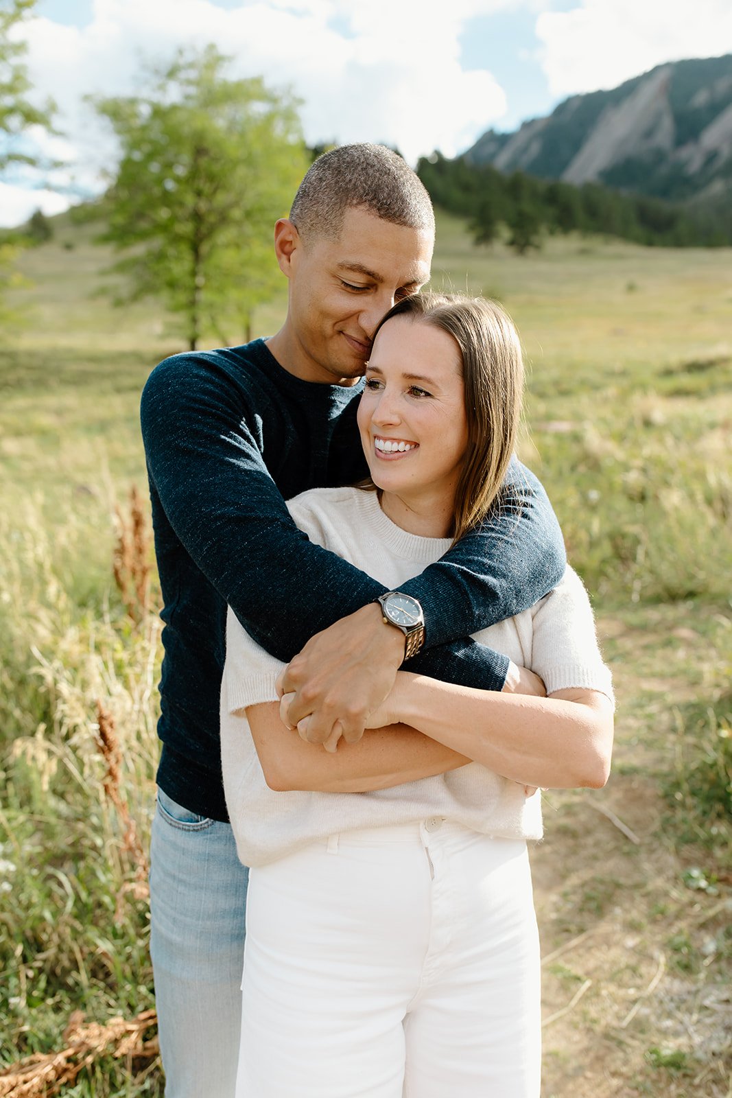 Couple hug during golden hour editorial engagement shoot.