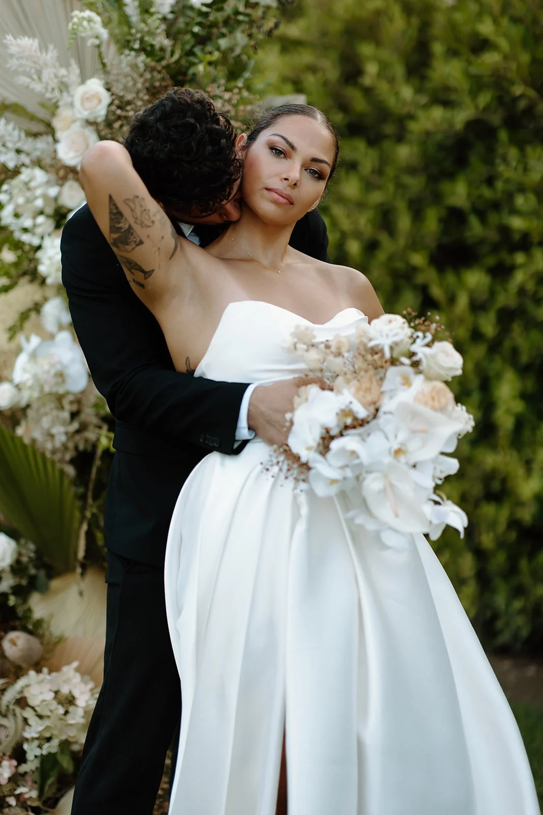Couple posed in an editorial style at this garden wedding.
