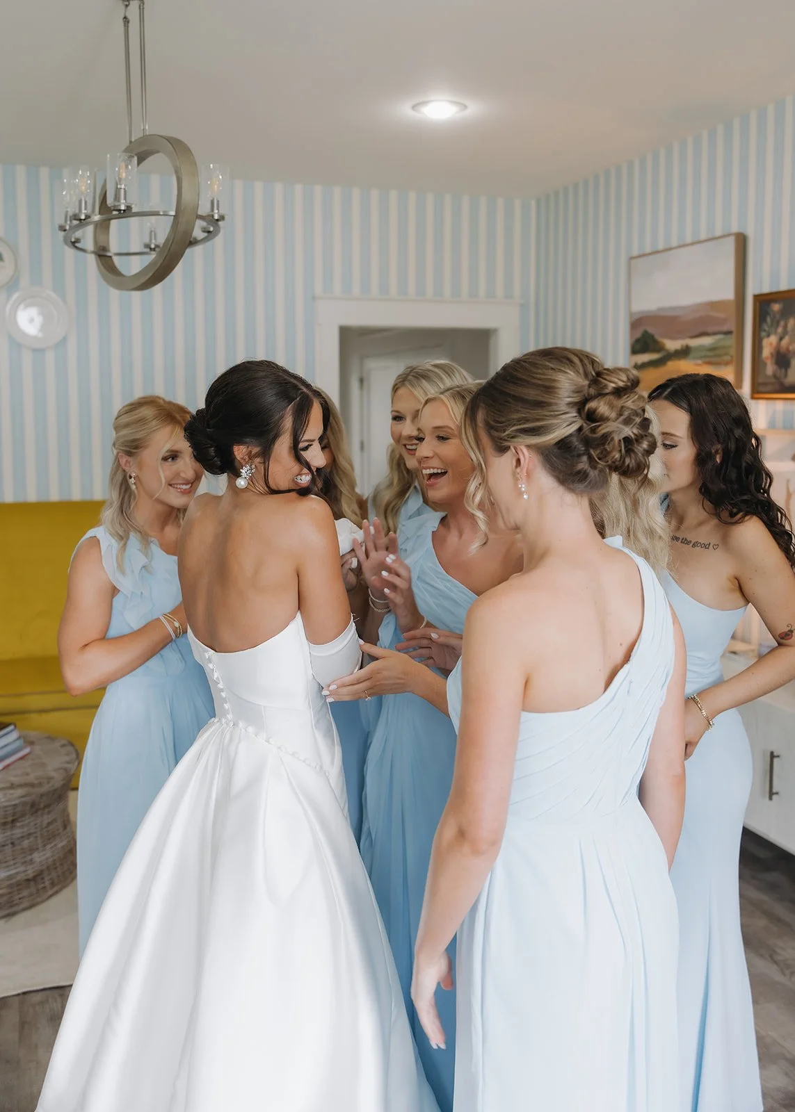 Bridesmaids sharing a happy moment with the bride on her wedding morning.