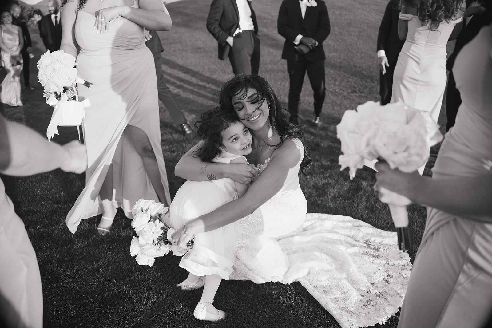 Documentary style photography moment of bride with flower girl.