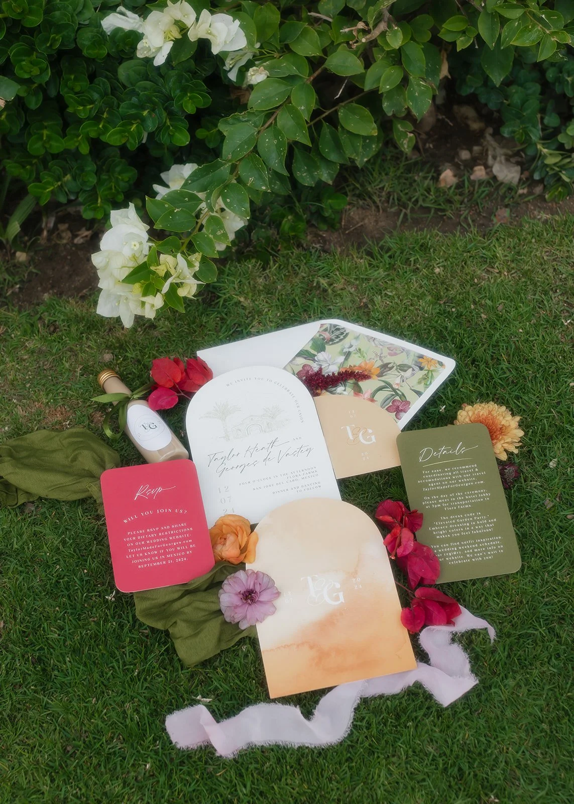 Wedding invitation suite styled on grass background.