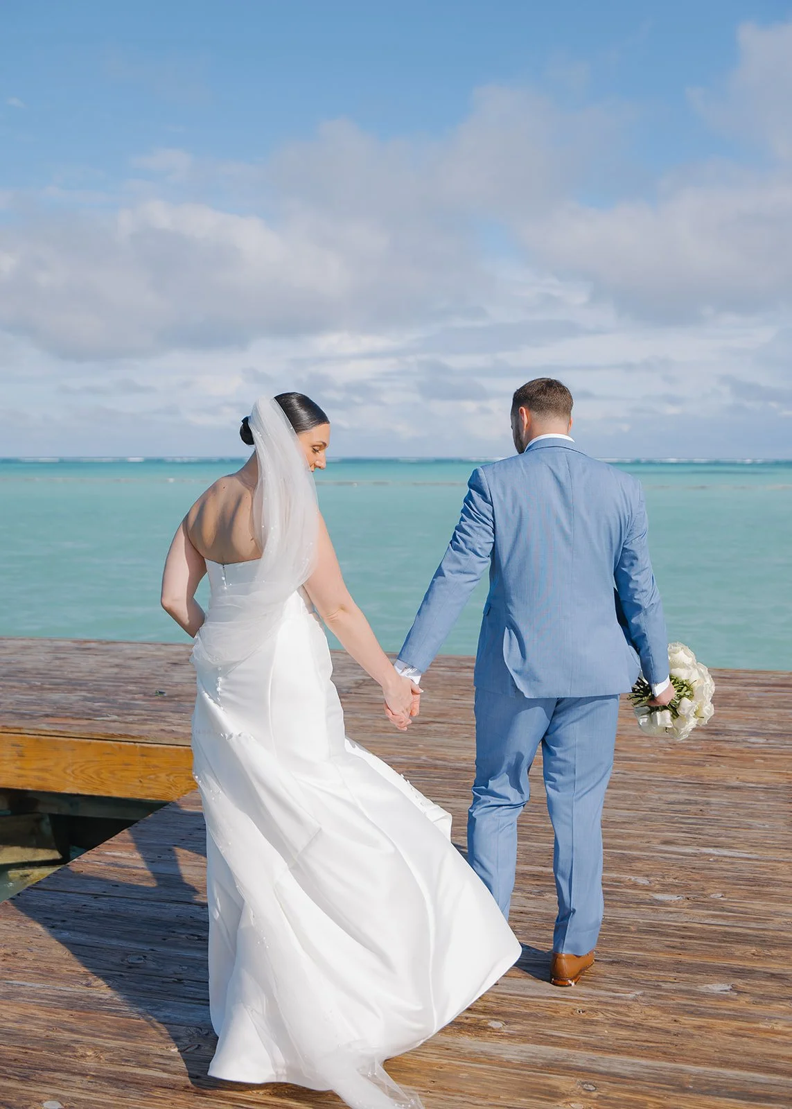 Bride and groom during oceanfront wedding portrait.