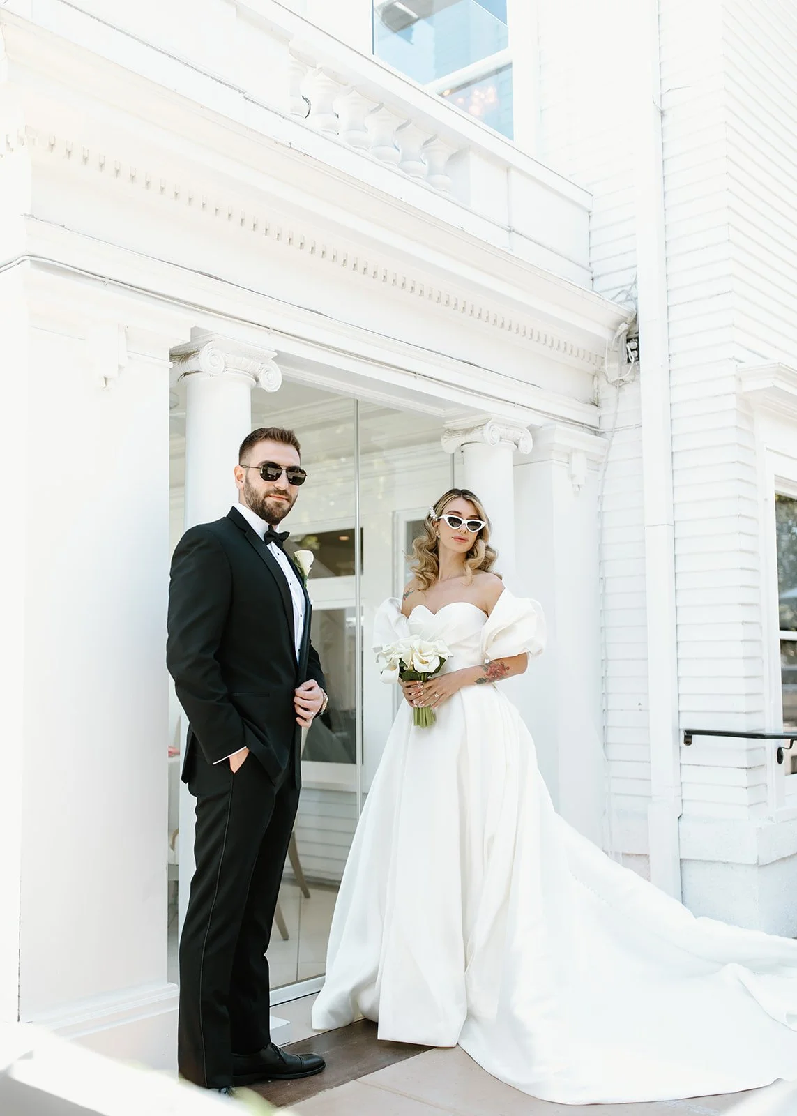 Elegant bride and groom portrait at coastal wedding venue.