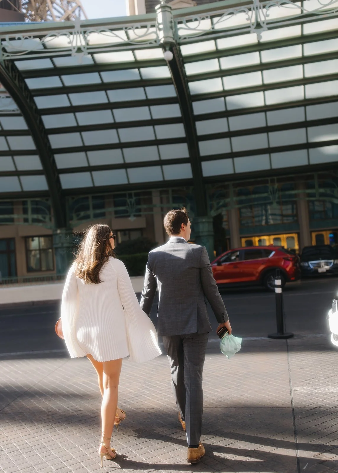 Couple cross street holding hands in Jacksonville, Florida.