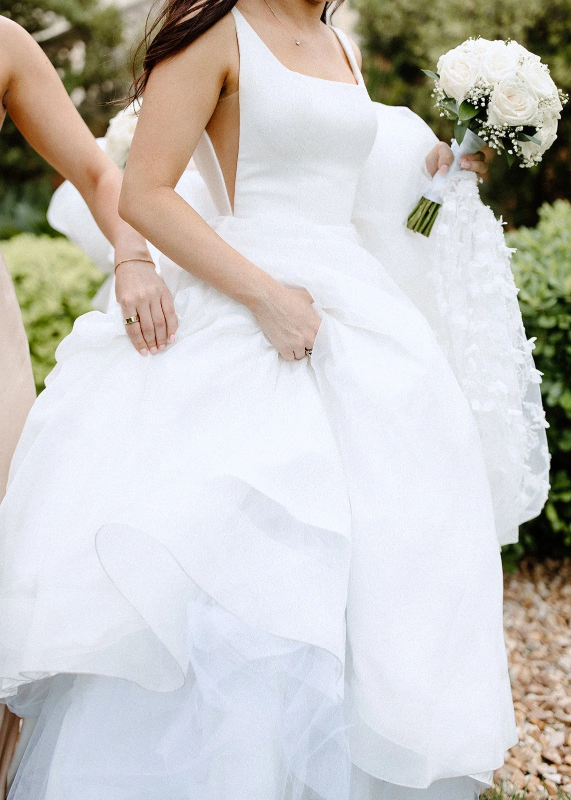 Detail shot of bride's dress as she poses.