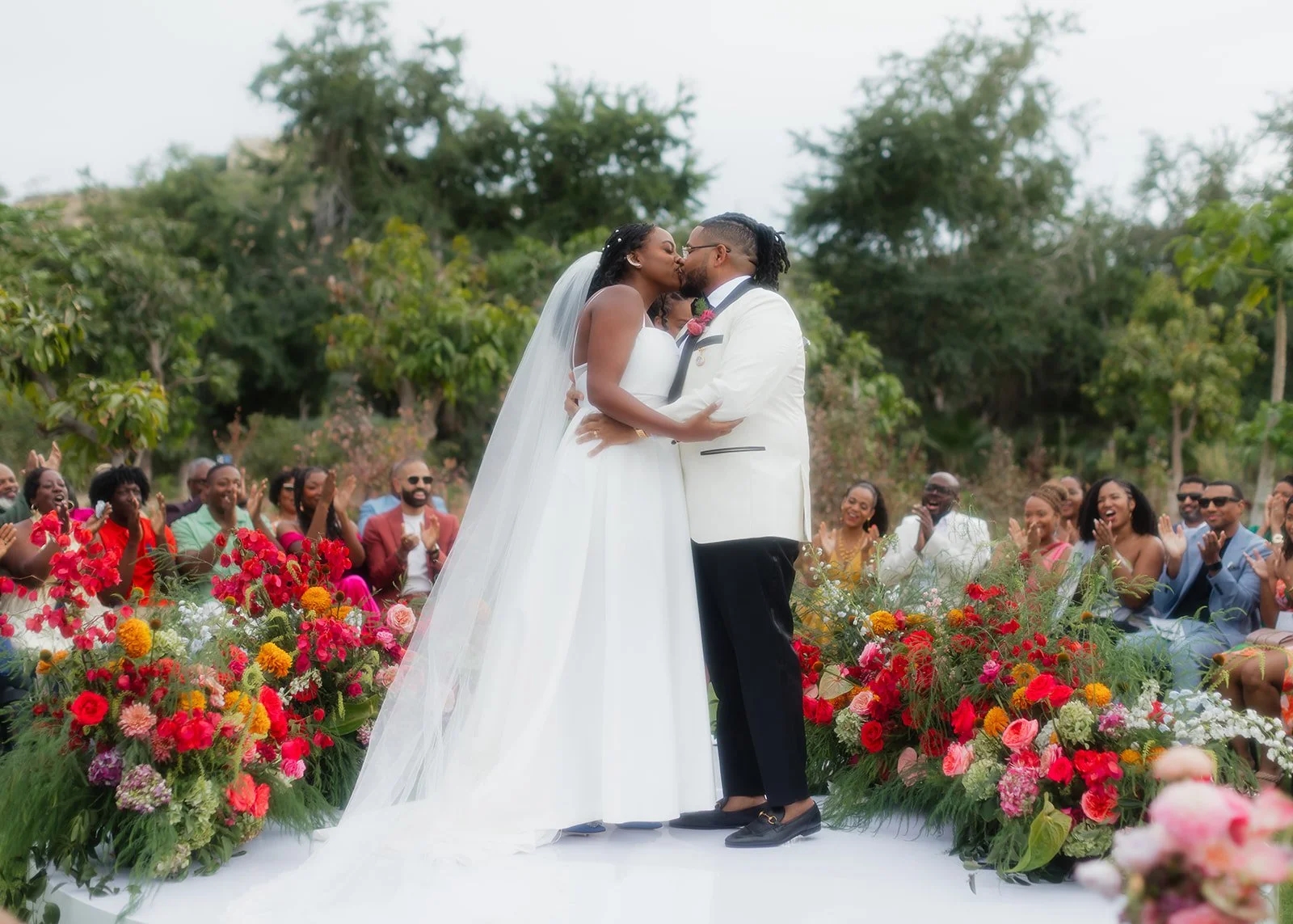 Couple sharing first kiss at wedding ceremony.