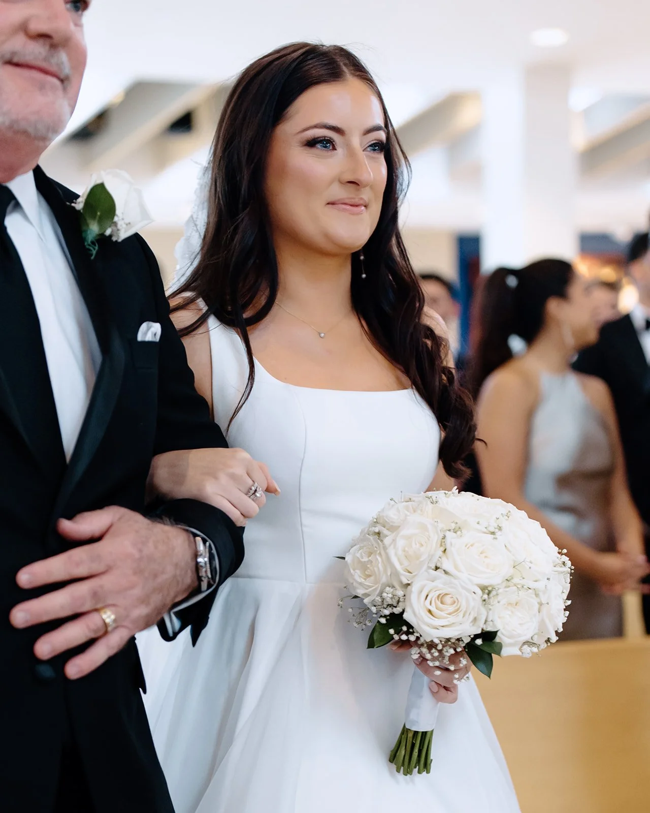 Bride's father walks her down the aisle during church wedding.