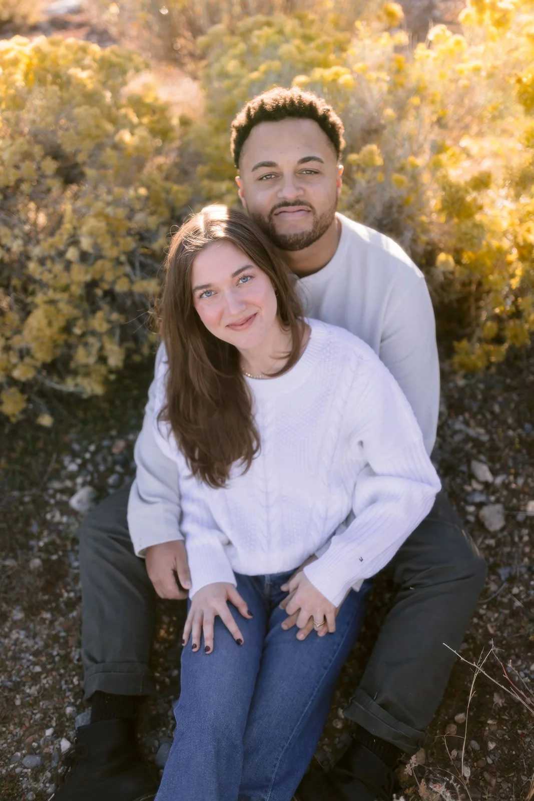 Bride and groom embracing in soft natural light.