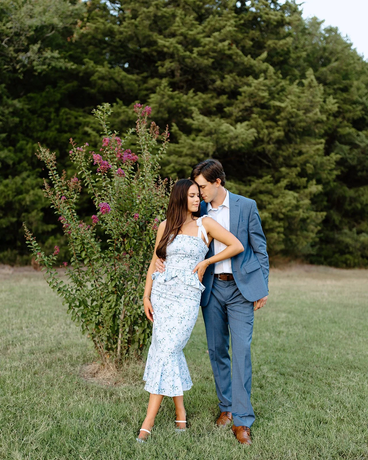 Romantic engagement photos at Washington Park in St. Augustine with greenery and soft natural light.