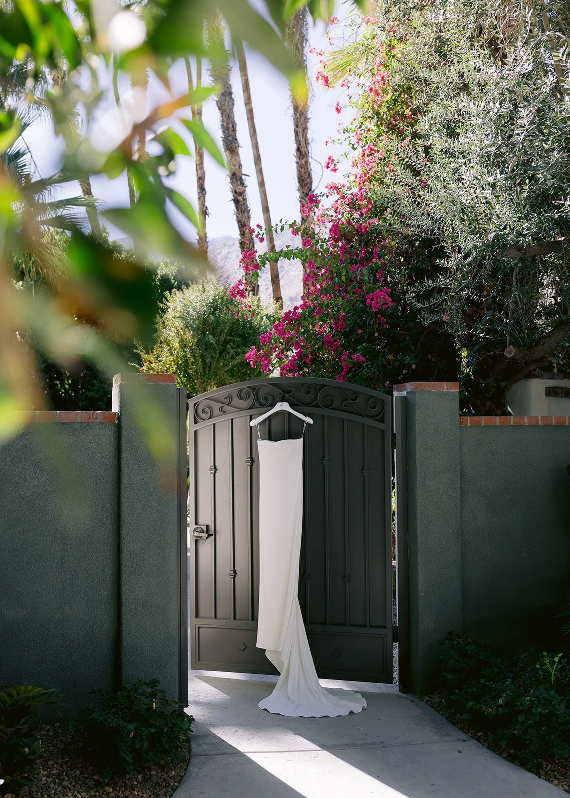 Wedding dress detail shot among the palm trees.
