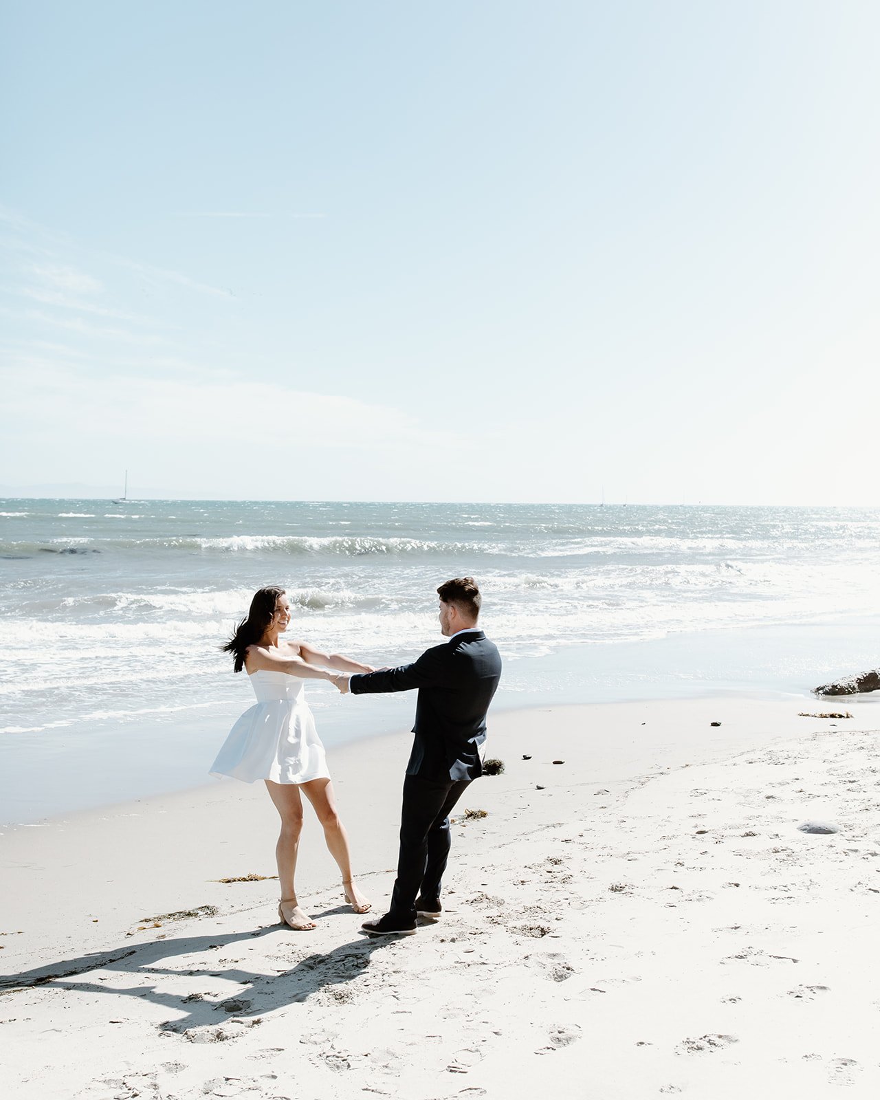 Beach engagement portrait at sunset with warm light.