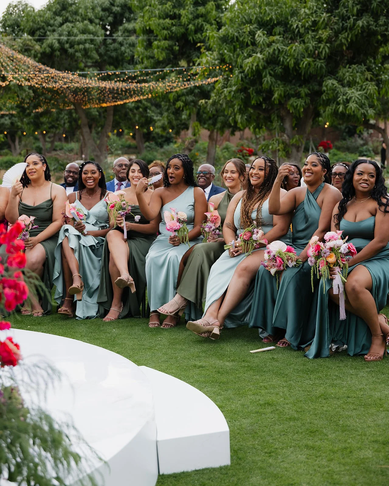 Candid moment of bridesmaids laughing during the wedding ceremony.