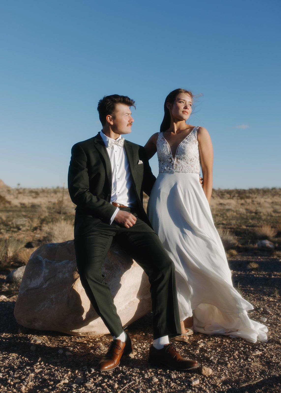 Bride and groom pose outdoor at their wedding event.