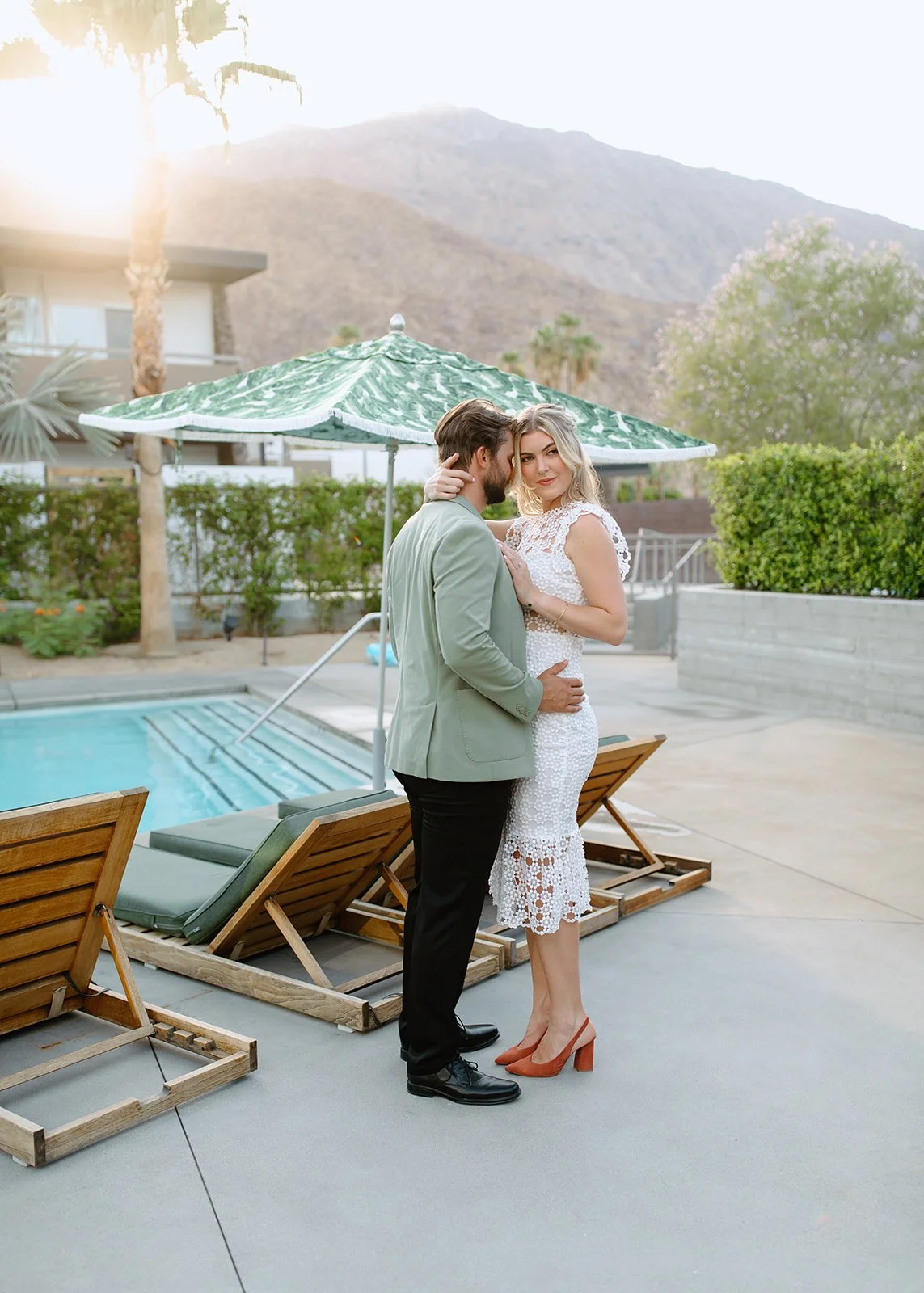 Couple posed poolside during modern engagement portrait session.