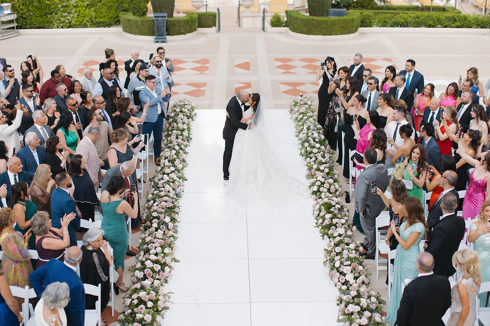 Bride and groom share a first kiss at their ceremony.
