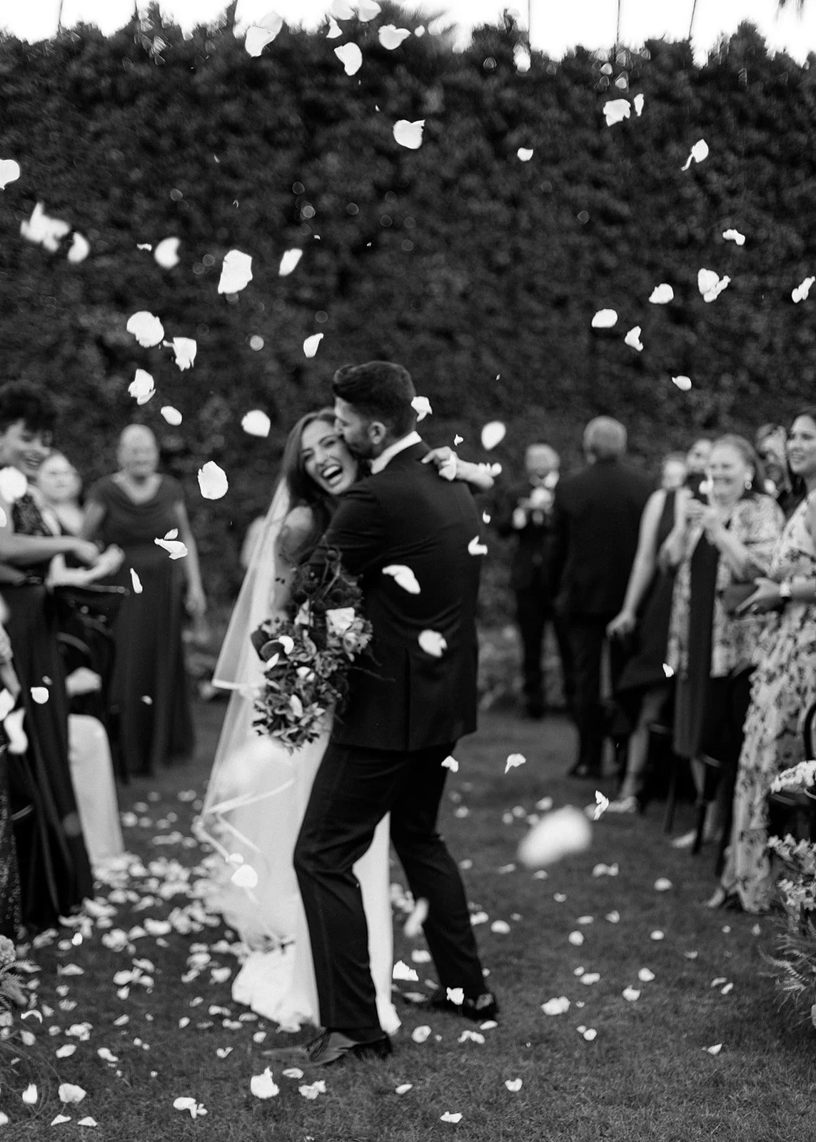 Bride and groom walking down aisle after first kiss.