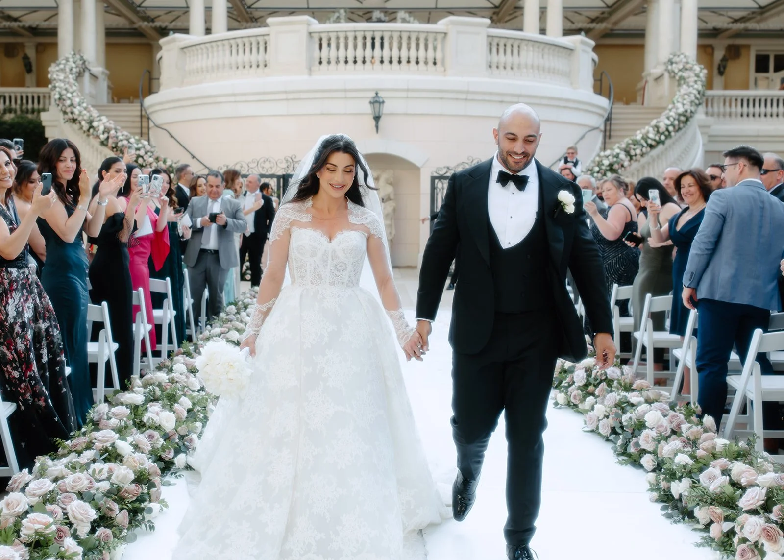 Bride and groom celebrating together during joyful wedding ceremony moment.