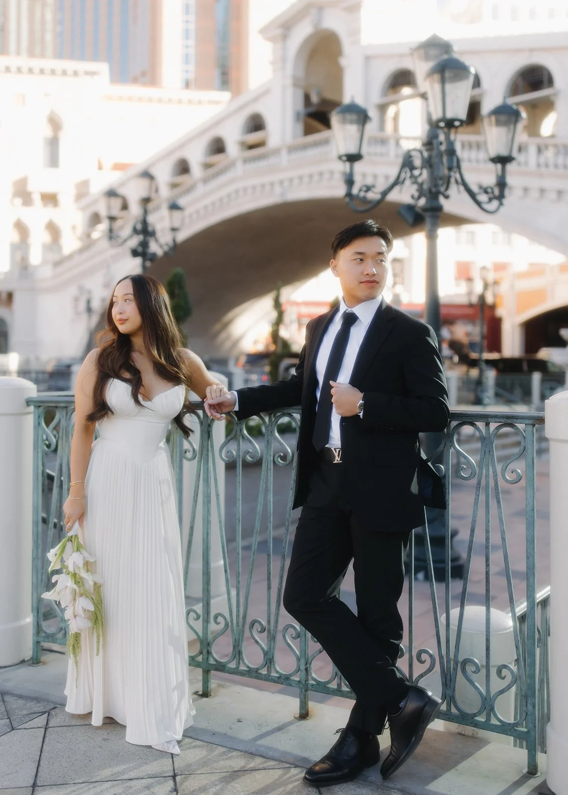 Editorial engagement portrait with clean architectural backdrop.