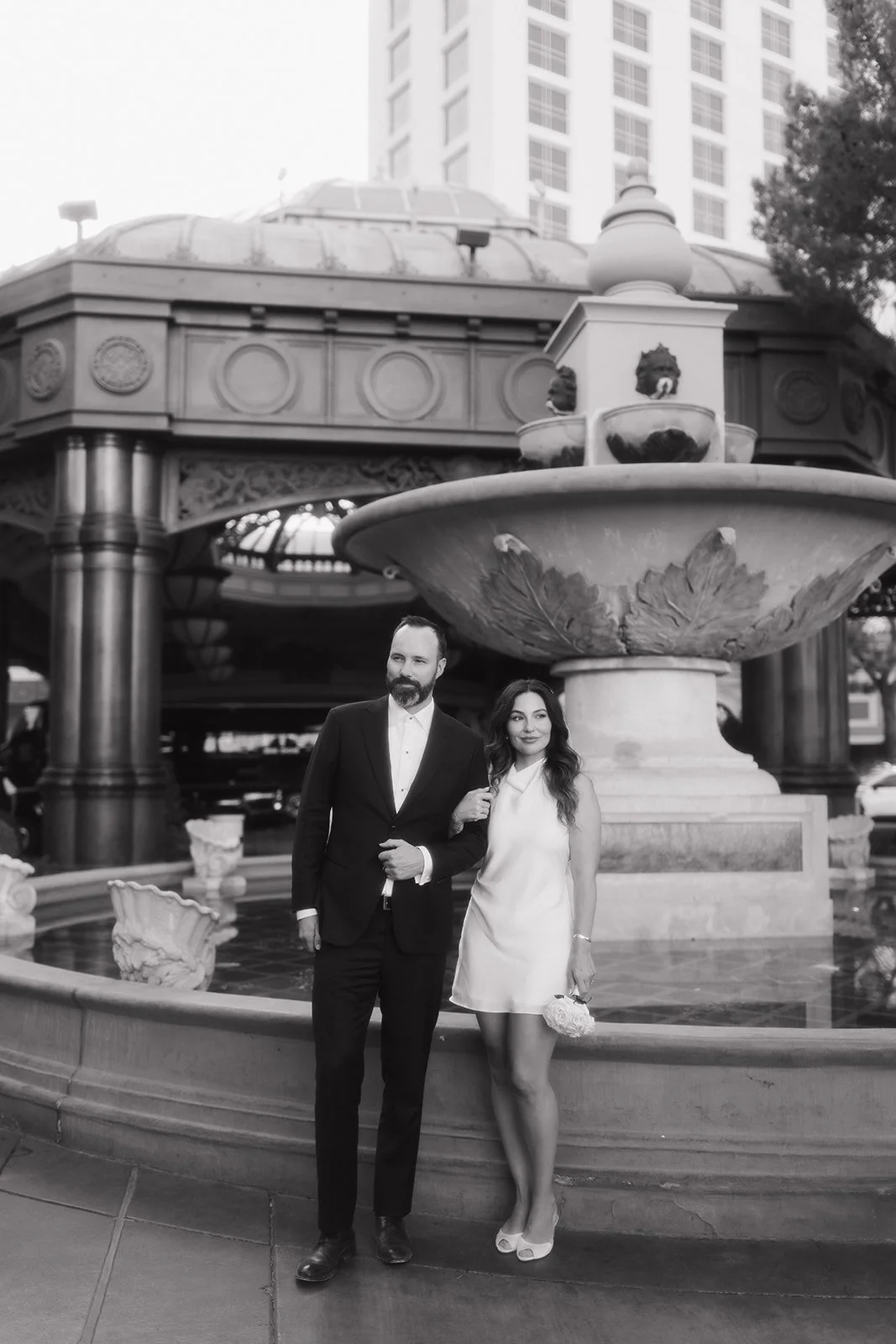 Editorial couple portrait framed by natural surroundings.